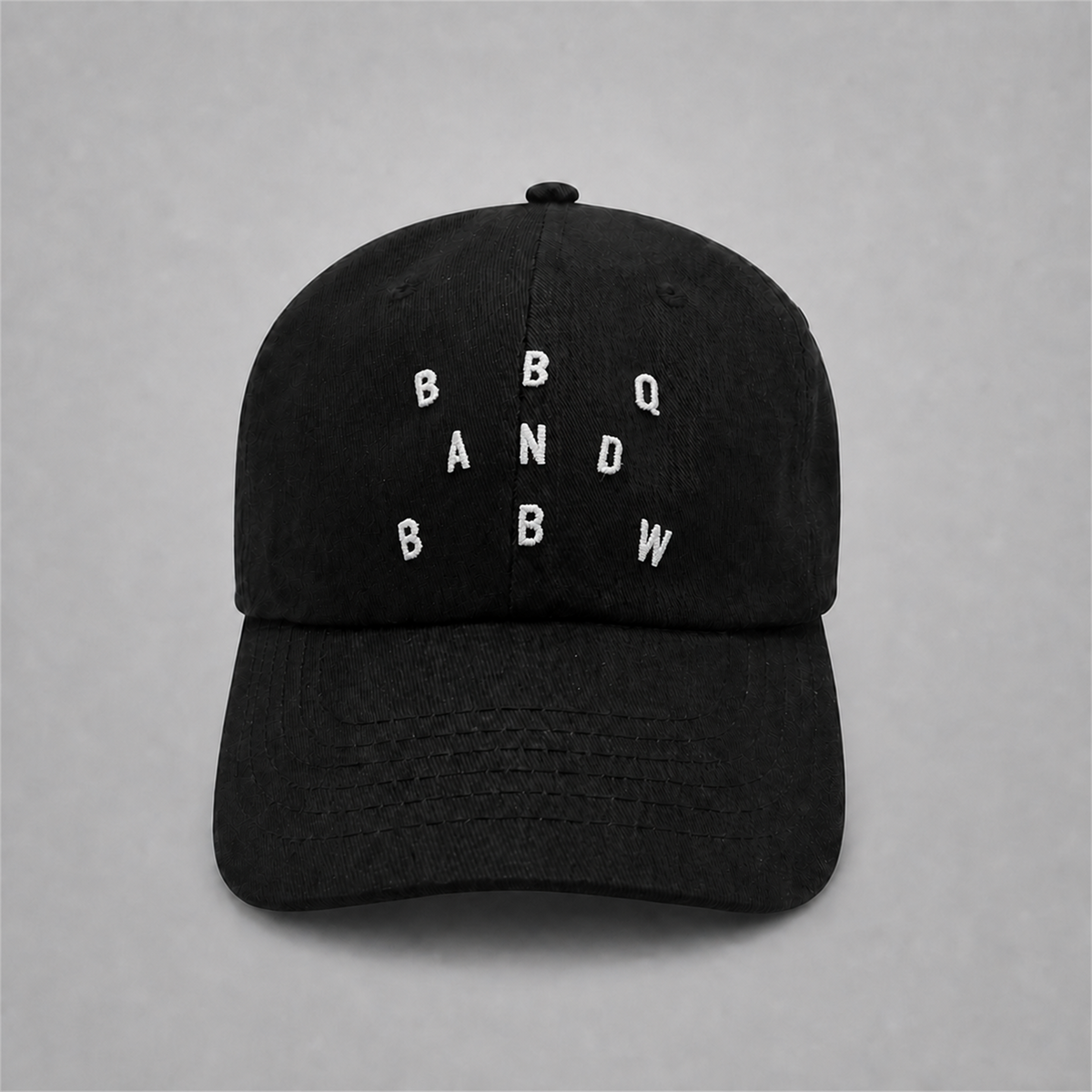 Black BnB embroidered cap on neutral studio gray background