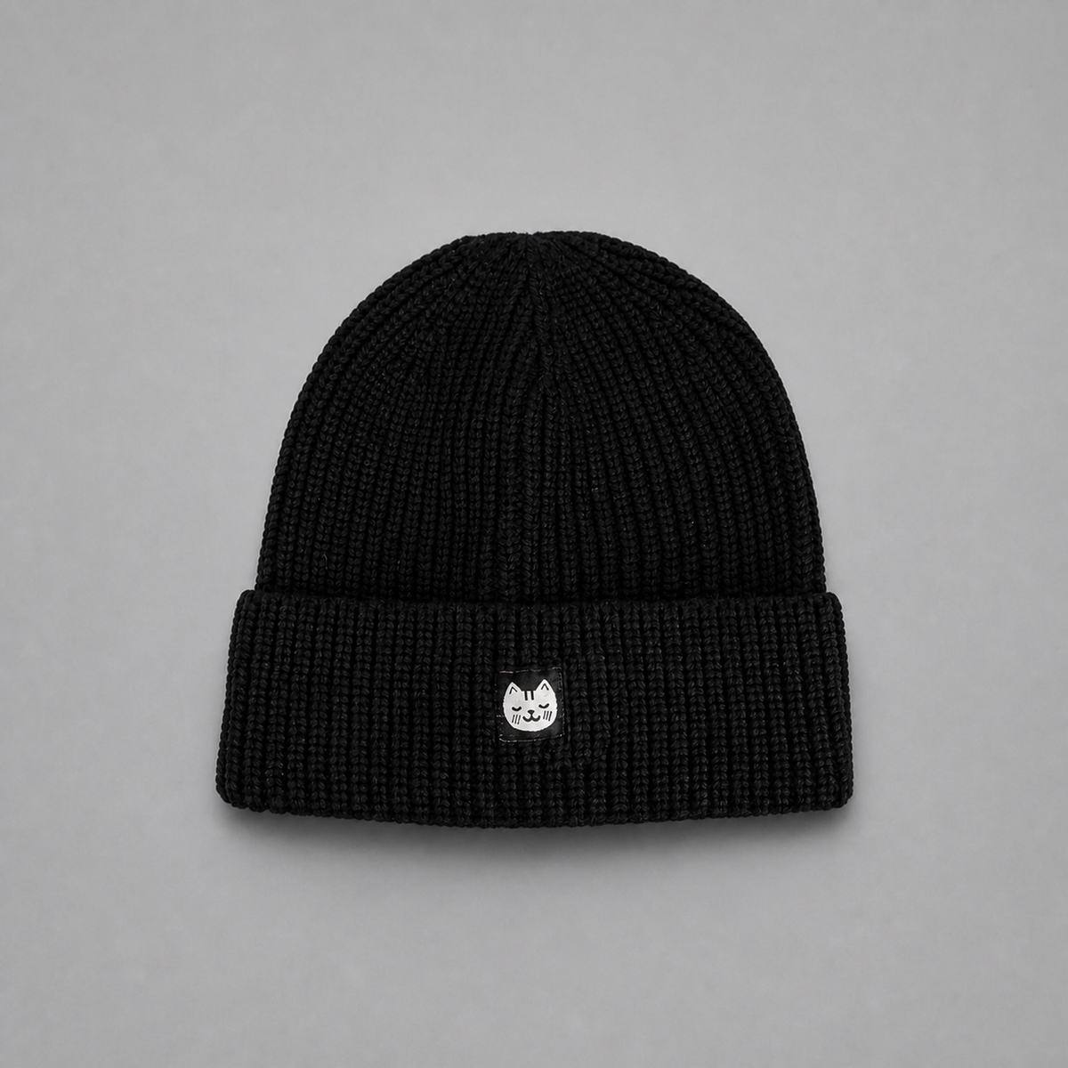 Black KnT Beanie on neutral studio gray background