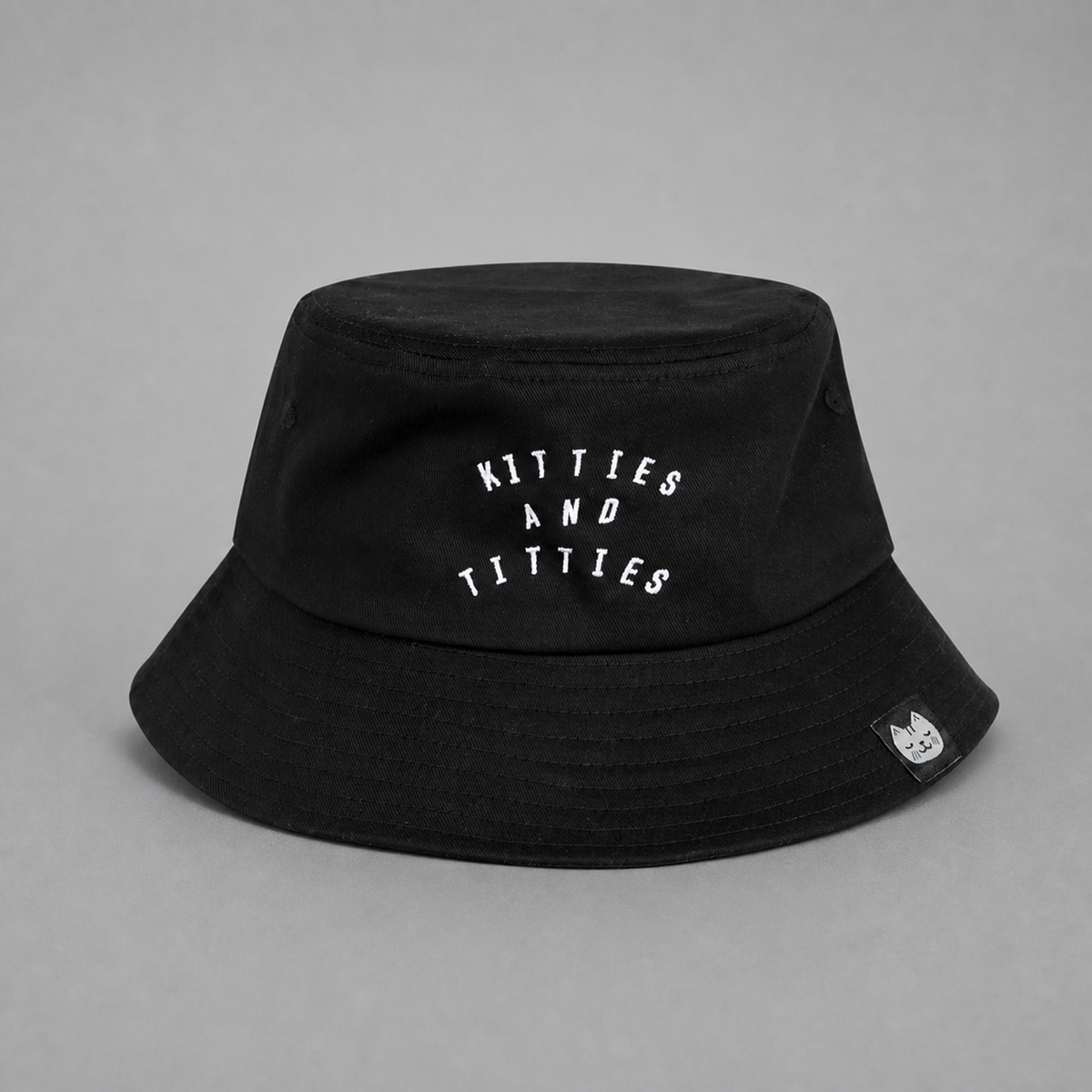 Black KnT Bucket Cap on neutral studio gray background