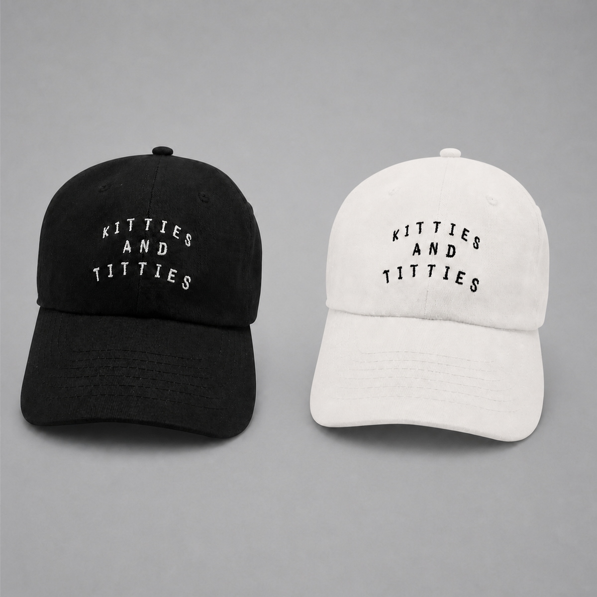 Black and white KnT Cap set on neutral studio gray background
