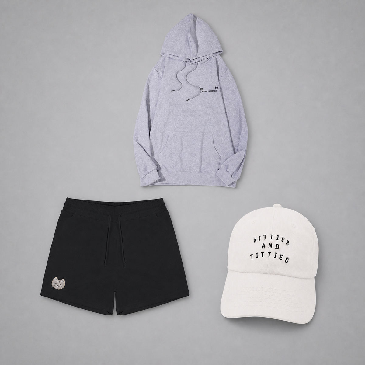 KnT Cap, hoodie, and shorts set on neutral studio gray background