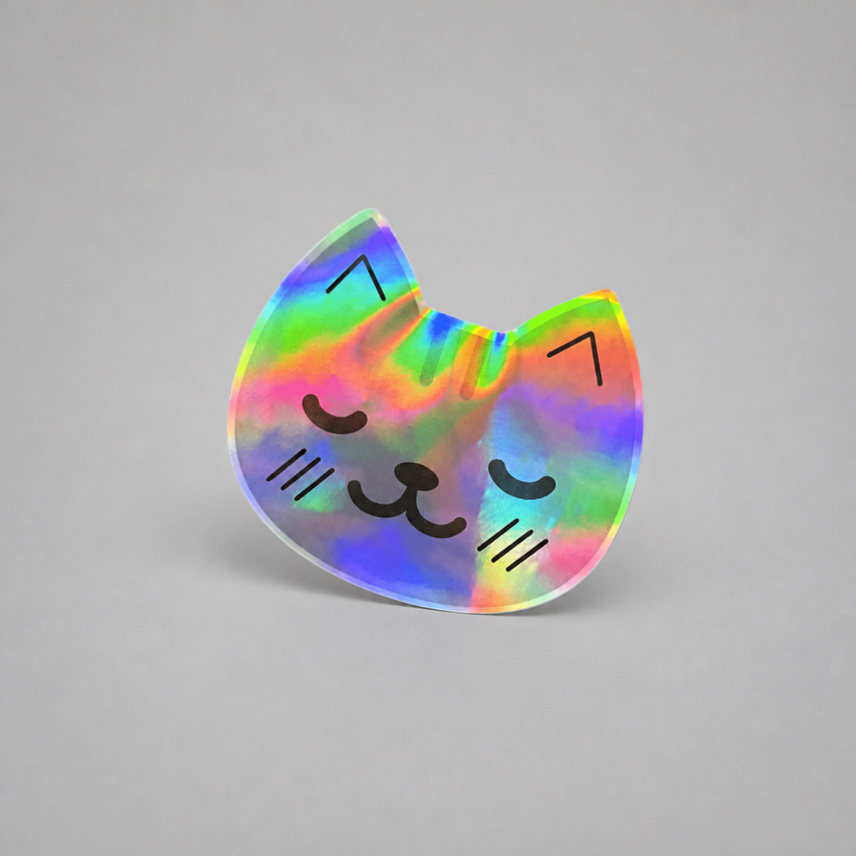 KnT holographic kitty sticker on neutral studio gray background