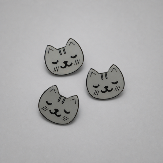 KnT kitty pin set on neutral studio gray background