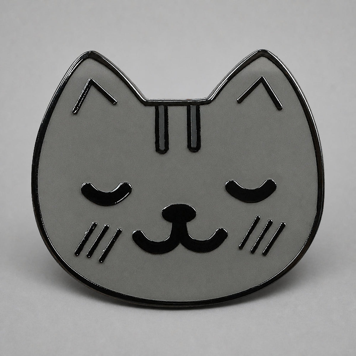 KnT kitty pin on neutral studio gray background