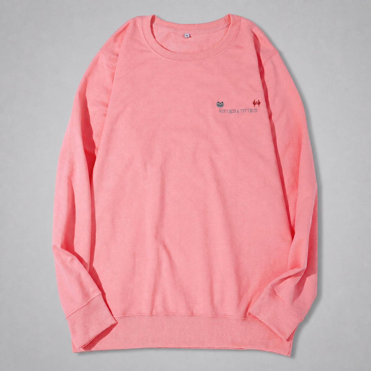 Pink KnT Sweater on neutral studio gray background